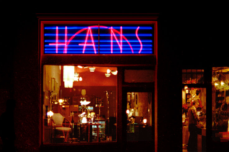 Los Angeles Magazine called this 'one of the ten best neon signs in Los Angeles.' This photo of the 'Hans' storefront taken on Melrose Avenue in 1979. The neon was designed by Eric Wrobbel and made by Charles Di Bona of Custom Neon, the primary force in the renaissance of neon in the 1970s. https://www.ericwrobbel.com/art/neon.htm