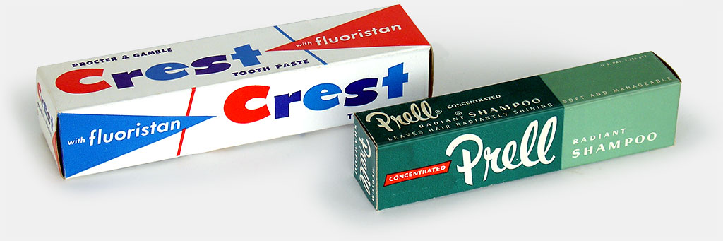 Vintage package design of especially high quality. Crest toothpaste and Prell shampoo, both from Proctor & Gamble, circa 1960. No amount of typographic tricks like shadows, shading, or 3-D effects so evident on other packaging has ever improved on, or substituted for, simply good design. These box designs are honest, and by implication have honest products inside. From the web's largest private collection of antiques & collectibles, https://www.ericwrobbel.com/collections/bathroom-2.htm