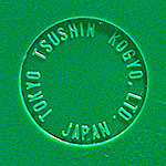 Early Sony TR-63 transistor radio models from 1957 were marked in a small debossed circle on the back with the company's original name, Tokyo Tsushin Kogyo, Ltd. Some included the model number in this area, some, like this one, did not. Later examples in 1958 dropped the Tokyo Tsushin name in favor of the new corporate name, Sony. From 'Collecting Variants' at the web's largest private collection of antiques & collectibles: https://www.ericwrobbel.com/collections/collecting-variants.htm