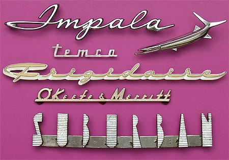 Vintage Collectible Nameplates: Impala is a Chevrolet model. Frigidaire is, or rather was, a brand of General Motors for household appliances. O'Keefe & Merritt made stoves. I can't place this nice Suburban nameplate but it may well have been from the GM vehicle of that name.  Temco is unknown. From 'More Nameplates and Lettering' at the web's largest private collection of antiques & collectibles: https://www.ericwrobbel.com/collections/nameplates-lettering-2.htm